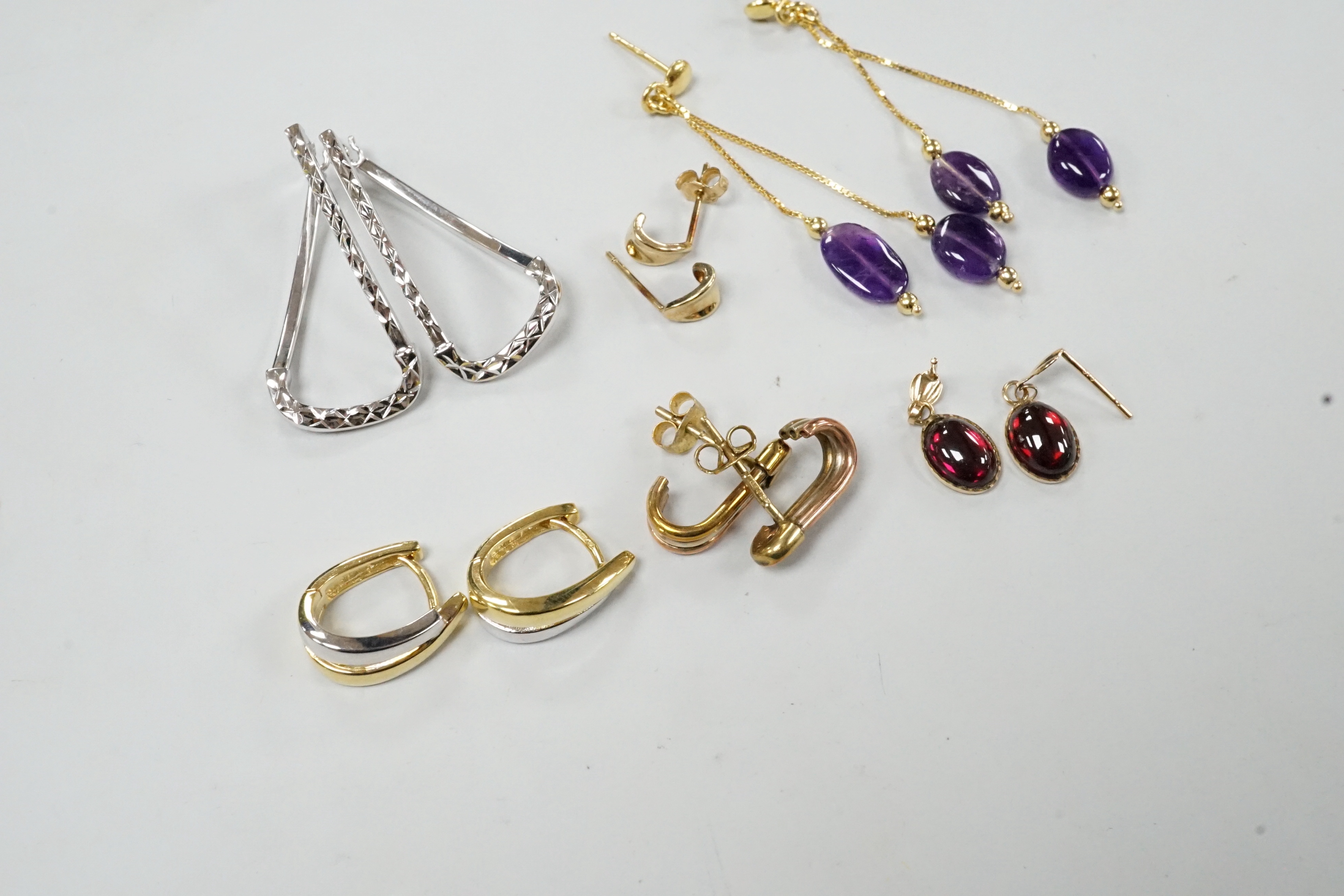 A modern pair of Italian 14k yellow metal and double drop amethyst set earrings, 50mm, gross weight 2.5 grams and five assorted pairs of 375 earrings, including one gem set, gross weight 8.3 grams.